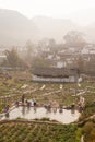 Peaceful village. Scenic ancient village landscape, a group of chinese woman washing at the old pool in potatoÃ¢â¬â¢s field in the